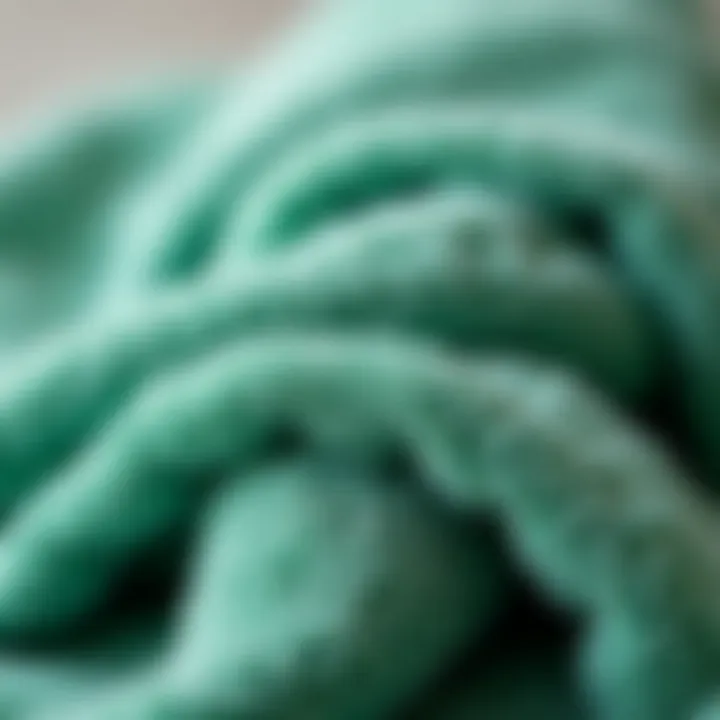 Close-up of soft fabric texture of luxurious green bath towels